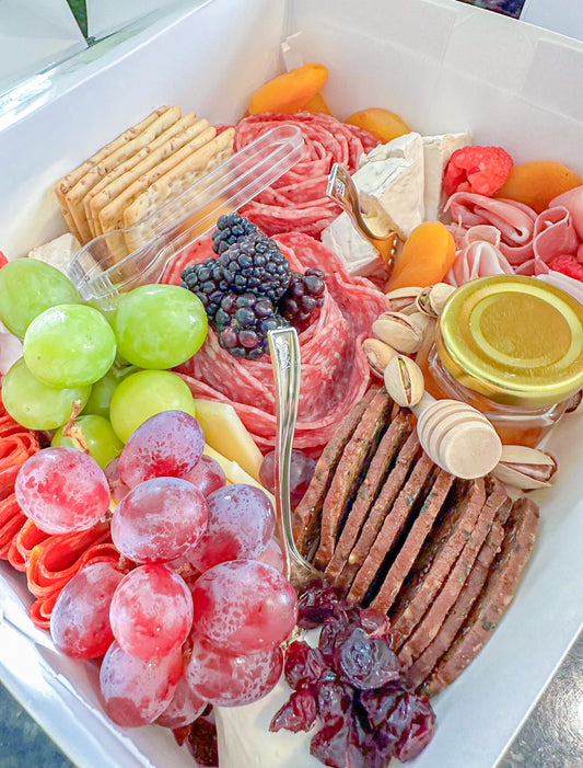 Mini charcuterie box for one to two people featuring premium meats, cheeses, crackers, and seasonal accompaniments – handcrafted by Olive Meats Wood in Montgomery, AL for snacks, meals, or small gatherings